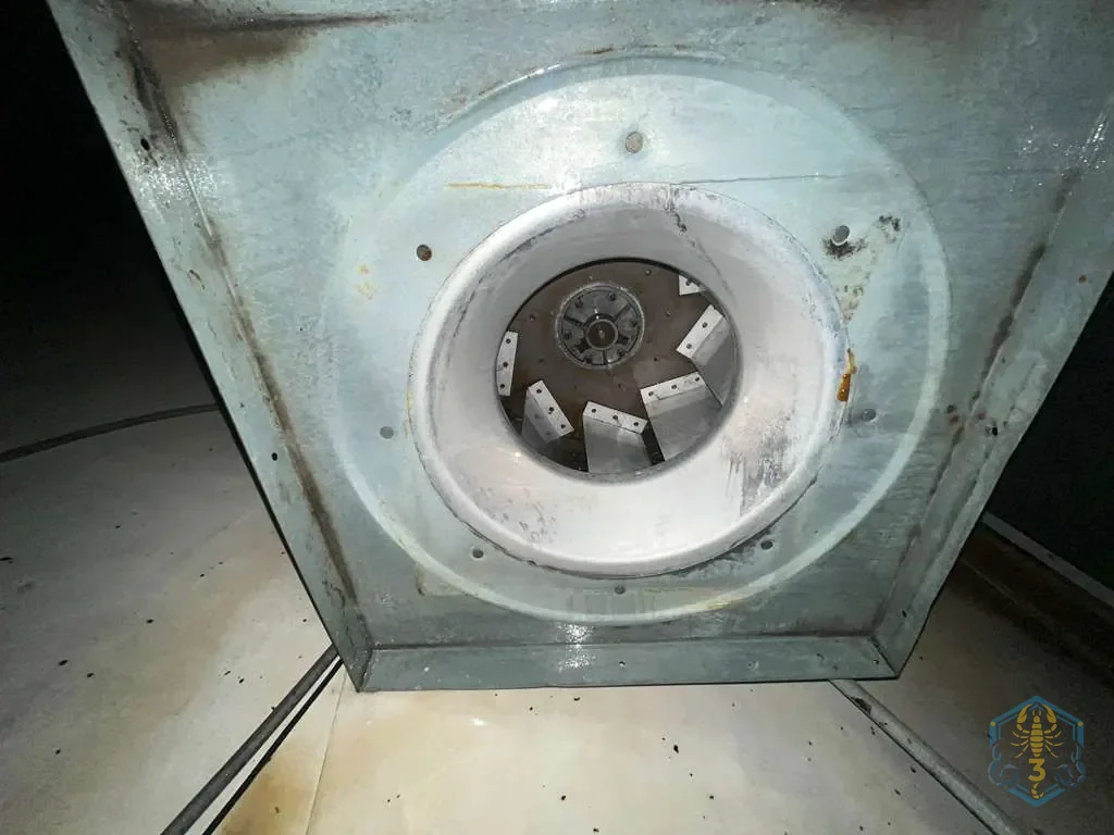 The same exhaust fan opening after cleaning, with the collar and fan wheel washed clean.
