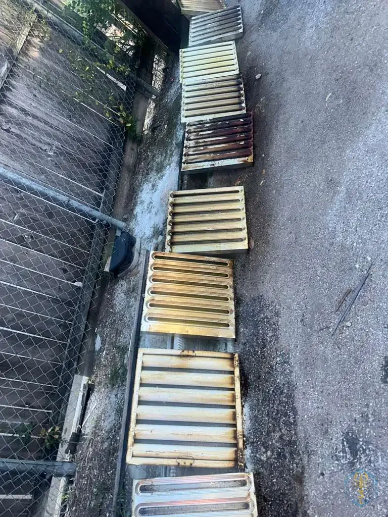Baffle filters removed from the hood, washed and laid out in a row to drain.